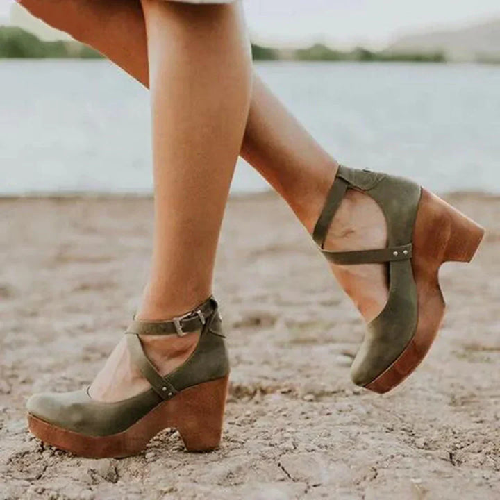 Femme portant des sandales vert avec talon épais, brides croisées et look décontracté en extérieur