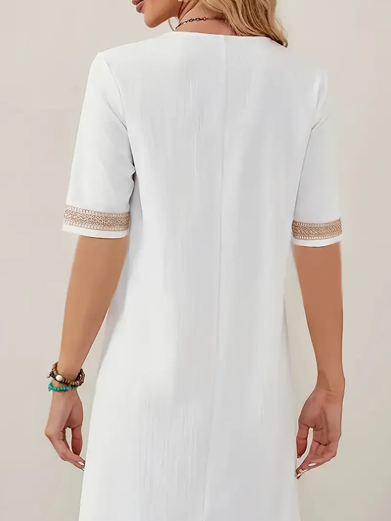 Vue de dos d’une robe blanc pour femme avec manches courtes, coupe décontractée et longueur au-dessus du genou